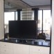 The flat-screen TV in the room swivels for viewing in both rooms.